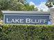 Welcoming Lake Bluff neighborhood sign surrounded by lush green hedges and mature trees at 359 Arbor Lakes Dr, Davenport, FL 33896