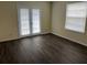 Bright room featuring wood-look flooring and a door with access to a balcony/patio at 4085 Dijon Dr # 4085J, Orlando, FL 32808