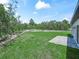 Expansive backyard features a lush lawn and a paved patio, perfect for outdoor entertaining and relaxation at 41 Orchid Ct, Kissimmee, FL 34759