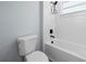 Bathroom featuring a toilet and bath tub with white tile surround and black fixtures at 41 Orchid Ct, Kissimmee, FL 34759