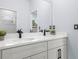 Bathroom featuring double vanity with white countertop and black fixtures at 41 Orchid Ct, Kissimmee, FL 34759