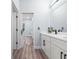 Bright bathroom featuring double vanity, modern fixtures, and wood-look flooring at 41 Orchid Ct, Kissimmee, FL 34759