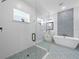 Bright bathroom featuring a glass shower, soaking tub, and decorative tile accents at 41 Orchid Ct, Kissimmee, FL 34759