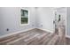 Bedroom with wood-look floors and a view of the outdoors at 41 Orchid Ct, Kissimmee, FL 34759