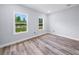 Bright and airy bedroom featuring two windows and wood-style flooring at 41 Orchid Ct, Kissimmee, FL 34759