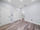 Spacious bedroom with wood-look floors, closet and bathroom access at 41 Orchid Ct, Kissimmee, FL 34759