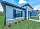 Charming single-story home with blue shutters and stone accents, surrounded by a lush, green lawn and landscaping at 41 Orchid Ct, Kissimmee, FL 34759