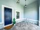 Inviting front porch with a blue front door, stone accents, neutral pavers and stylish hanging lights at 41 Orchid Ct, Kissimmee, FL 34759
