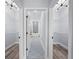 Hallway featuring walk-in closets on either side and bathroom at end at 41 Orchid Ct, Kissimmee, FL 34759