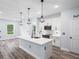 Bright kitchen featuring an island with modern appliances and sleek, decorative pendant lighting at 41 Orchid Ct, Kissimmee, FL 34759