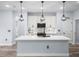 Bright kitchen showcasing a large island, modern appliances, and stylish pendant lighting at 41 Orchid Ct, Kissimmee, FL 34759