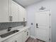 Well-organized laundry room with sleek countertops, white cabinets, and modern fixtures at 41 Orchid Ct, Kissimmee, FL 34759