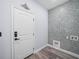 Well-lit laundry room featuring a decorative tiled wall at 41 Orchid Ct, Kissimmee, FL 34759
