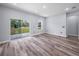 A bright living room with wood-look floors and sliding glass doors to the outdoors at 41 Orchid Ct, Kissimmee, FL 34759