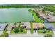 Aerial view of home and surrounding community with lake and mature landscaping at 4244 Windchime Ln, Lakeland, FL 33811