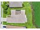 Aerial shot of a home's roof, screened patio, landscaping and proximity to the lake at 4244 Windchime Ln, Lakeland, FL 33811