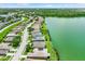 Beautiful aerial view of homes in a lakeside community with lush trees in the background at 4244 Windchime Ln, Lakeland, FL 33811