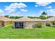 Backyard of home with lush green grass and mature landscaping at 4244 Windchime Ln, Lakeland, FL 33811