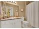 Bright bathroom featuring a shower with curtain and white vanity at 4244 Windchime Ln, Lakeland, FL 33811