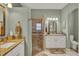 Bathroom with dual vanities, granite countertops, decorative mirrors, and tiled walk-in shower at 4244 Windchime Ln, Lakeland, FL 33811