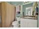 Bathroom features a shower with a shower curtain and white sink with a vanity at 4244 Windchime Ln, Lakeland, FL 33811