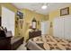 Bedroom with light yellow walls featuring a television, and double door closet at 4244 Windchime Ln, Lakeland, FL 33811
