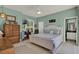 Bright bedroom with a white bed frame, neutral-colored walls, and view into bathroom at 4244 Windchime Ln, Lakeland, FL 33811