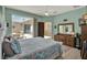 Light and bright bedroom featuring access to outdoor patio and ensuite bath at 4244 Windchime Ln, Lakeland, FL 33811