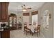 Well-lit dining area features a wood table, four chairs, china cabinet, tile floor, and large windows at 4244 Windchime Ln, Lakeland, FL 33811