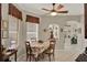 Well-lit dining area features a wood table, four chairs, display shelving, and large windows at 4244 Windchime Ln, Lakeland, FL 33811