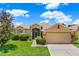 Charming one-story home with manicured lawn, mature landscaping, and a beige color scheme at 4244 Windchime Ln, Lakeland, FL 33811