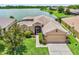 Lovely one-story home near a lake, featuring a well-kept lawn and pleasing landscape design at 4244 Windchime Ln, Lakeland, FL 33811