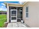Exterior view of screened-in lanai with lake views and lush green landscaping at 4244 Windchime Ln, Lakeland, FL 33811