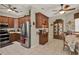 Well lit kitchen with stainless steel appliances, tile floor, wood cabinets, and ceiling fan at 4244 Windchime Ln, Lakeland, FL 33811