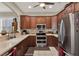 Bright eat-in kitchen features stainless appliances, wood cabinets, tile flooring and lots of counter space at 4244 Windchime Ln, Lakeland, FL 33811