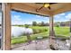 Enjoy stunning water views from this screened lanai with ceiling fan and comfortable seating at 4244 Windchime Ln, Lakeland, FL 33811