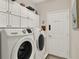 Clean laundry room with modern washer and dryer plus ample cabinet space at 4244 Windchime Ln, Lakeland, FL 33811