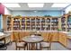 Cozy library with floor-to-ceiling bookshelves and tables for reading and studying at 4244 Windchime Ln, Lakeland, FL 33811