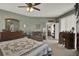 Spacious main bedroom with neutral walls, plush carpet, dresser, desk, and sitting area at 4244 Windchime Ln, Lakeland, FL 33811