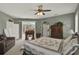Spacious main bedroom with neutral walls, plush carpet, desk, seating area and slider to exterior at 4244 Windchime Ln, Lakeland, FL 33811