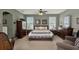 Spacious main bedroom with a ceiling fan, two large windows, neutral walls, and plush carpet at 4244 Windchime Ln, Lakeland, FL 33811