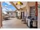 Covered patio with ceiling fans and various seating arrangements and a grill at 4244 Windchime Ln, Lakeland, FL 33811