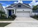 Charming single-Gathering home featuring a two-car garage, well-maintained landscaping, and a welcoming blue front door at 4424 Seven Canyons Dr, Kissimmee, FL 34746