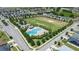 Beautiful aerial view of the community pool and recreational area with mature trees at 4505 Hummingbird Ln, Haines City, FL 33844