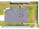 Aerial view of a well maintained roof, green lawn, and fenced backyard at 4505 Hummingbird Ln, Haines City, FL 33844