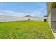 Spacious backyard area with lush green grass and a privacy fence at 4505 Hummingbird Ln, Haines City, FL 33844