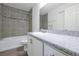 Bathroom boasts a sleek vanity with granite counters, tiled walls, and a bathtub and shower combo at 4505 Hummingbird Ln, Haines City, FL 33844
