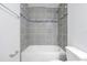 Bathroom showcasing a tiled shower and bathtub combo with modern fixtures and stylish design at 4505 Hummingbird Ln, Haines City, FL 33844