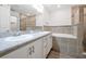 Bathroom featuring a double vanity, large mirror, granite countertop, shower and a soaking tub at 4505 Hummingbird Ln, Haines City, FL 33844