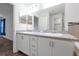 Bathroom featuring a double vanity, granite countertop, large mirror and stylish decor at 4505 Hummingbird Ln, Haines City, FL 33844
